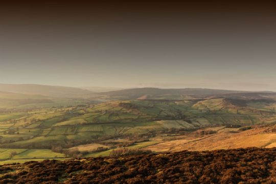 Photo: Pennine moorland view with green fields in the distance